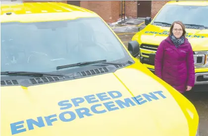  ?? SHAUGHN BUTTS ?? Jessica Lamarre, Edmonton’s acting director for traffic safety, reveals two of the photo radar trucks that got a bright makeover to make them more visible to motorists. “Automated enforcemen­t is one tool in the toolbox,” Lamarre says of the safety program.