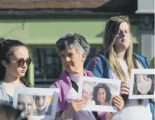  ??  ?? Photos showing the victims were held up at the ceremony.