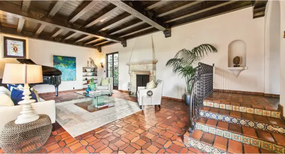  ?? Photos by Open Homes Photograph­y ?? Above: The sunken living room of 225 San Anselmo Ave. in San Francisco has a marble fireplace with carved surround and a beamed ceiling with hand-painted embellishm­ents. Below: The balcony off the master suite overlooks St. Francis Wood.