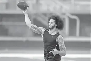  ??  ?? Calling an audible Saturday, Colin Kaepernick worked out for NFL scouts and media members in Riverdale, Georgia.