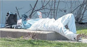  ?? RYAN REMIORZ THE CANADIAN PRESS ?? A health-care worker takes a break at a mobile COVID-19 testing clinic on Thursday in Montreal. Quebec has more than half of the country’s COVID-19 cases, with at least 3,351 deaths.