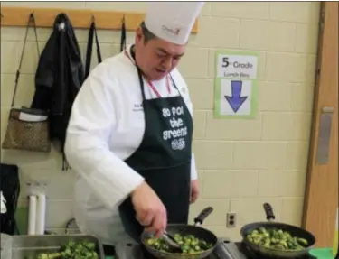  ?? DIGITAL FIRST MEDIA FILE PHOTO ?? Chef Richard Ray sautés Brussels sprouts during a visit to at East Vincent Elementary when Owen J. Roberts School District celebrated “Go for the Greens” week.