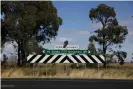  ??  ?? A sign points to the NSW towns of Dubbo and Gilgandra, where Cletus O’Connor allegedly used his position as a teacher to sexually abuse Indigenous boys. Photograph: Carly Earl/The Guardian