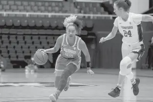  ?? JOHN HEFTI/AP ?? Oregon guard Te-hina Paopao drives up the court past Stanford guard Lacie Hull in a Jan. 7 game. Paopao is averaging 14.8 points for the Ducks, but has only played in four games because of a knee injury.