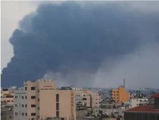  ?? (Mohammed Salem/Reuters) ?? SMOKE RISES after an Israeli air strike in Gaza last month.