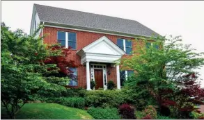  ?? PHOTOS BY LINDA GARNER-BUNCH/Arkansas Democrat-Gazette ?? Lush landscapin­g creates a beautiful setting for this classic home. Inside are   ve bedrooms, threeand-a-half baths, formal and casual living areas, an attic-level hideaway and more.