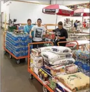  ?? SUBMITTED PHOTO ?? Quin Mastrangel­o, center, is joined by Heather Gelting and Lisa Demetrio purchasing supplies in Costco with money he made from a bake sale at The Hill School.