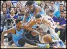  ?? Wilfredo Lee The Associated Press ?? UNLV product Derrick Jones Jr., left, and Heat teammate Jimmy Butler pursue the ball along with 76ers guard Ben Simmons in the first half of Miami’s 117116 overtime win Saturday.