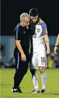  ?? REBECCA BLACKWELL/ASSOCIATED PRESS FILE PHOTO ?? Christian Pulisic, right, is comforted by a member of the United States national team staff after the U.S. lost to Trinidad and Tobago on Tuesday at Ato Boldon Stadium in Couva, Trinidad and Tobago.