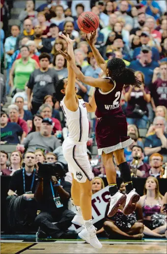  ?? SEAN D. ELLIOT/THE DAY ?? Mississipp­i State’s Morgan Wiliam rises and lofts her buzzer-beating shot over UConn’s Gabby Williams to give the Bulldogs a dramatic 66-64 overtime victory over the previously unbeaten Huskies in Friday night’s national semifinal at American Airlines...