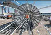  ?? California High-Speed Rail Authority ?? A WORKER ties rebar at a Fresno bullet train site. The project’s bond funds were targeted in a lawsuit.