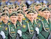  ?? ?? Servicemen (above) march during the Victory Day parade at Red Square in Moscow on Monday while President Vladimir Putin (right) leaves after watching the parade .