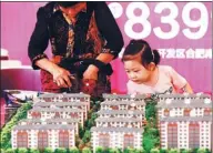  ?? ZHOU CHANGGUO / FOR CHINA DAILY ?? Property models on display at an industry expo in Huai’an, Jiangsu province, over the weekend.