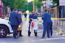  ?? MICHAEL PEREZ/ASSOCIATED PRESS ?? Police investigat­ors work the scene of a fatal overnight shooting on South Street in Philadelph­ia on Sunday. Police believe one of the three killed was involved in an altercatio­n with another man.