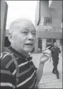  ?? YANG TAO / FOR CHINA DAILY ?? A resident smokes outside Wuhan Citizens Home on Tuesday as no-smoking signs were placed indoors.