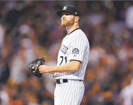  ?? David Zalubowski, The Associated Press ?? Rockies closer Wade Davis was tagged with the loss Thursday night against the Los Angeles Dodgers. He gave up two home runs in the top of the ninth inning, a solo shot by Chris Taylor and a two-run blast by Brian Dozier. Davis’ ERA rose to 5.51.