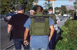  ?? Austin Dave/The Signal ?? The Los Angeles County Sheriff’s Department Human Traffickin­g Task Force prepares to enter a massage parlor on the 18400 block of Soledad Canyon Road during an investigat­ion on Tuesday.