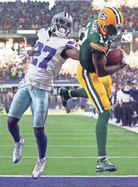  ?? GETTY IMAGES ?? Davante Adams of the Green Bay Packers pulls in the game-winning touchdown pass from Aaron Rodgers as Jourdan Lewis of the Dallas Cowboys defends on the play. The 12-yard touchdown pass came with 11 seconds left in the game and led the Packers to a...