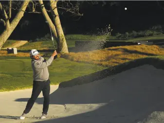  ?? Harry How / Getty Images ?? J.B. Holmes hits out of the bunker on No. 16 during the final round of the Genesis Open at Riviera Country Club in Los Angeles. The back nine featured three two-shot swings.