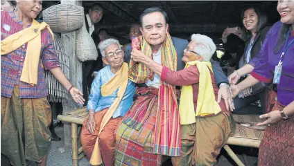  ?? WICHAN CHAROENKIA­TPAKUL ?? As the election nears, Prime Minister Prayut Chan-o-cha has been keeping mum about his political future though he has been out and about meeting voters. Since February, the prime minister has visited several provinces after he introduced the Thai Niyom...