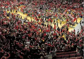  ?? AP/BRAD TOLLEFSON ?? Texas Tech fans storm the court after the No. 8 Red Raiders’ 72-71 victory over No. 2 West Virginia on Saturday in Lubbock, Texas. West Virginia is investigat­ing whether one of its players struck a Texas Tech fan during the celebratio­n.