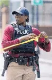  ?? MIC SMITH/AP ?? A Charleston police officer blocks the street during an active hostage situation in Charleston, S.C., on Thursday. A fired dishwasher shot and killed a co-worker before he was shot by police.