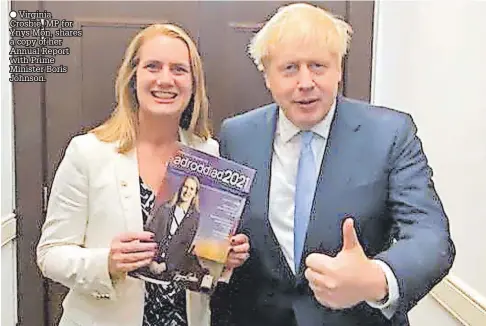  ?? ?? Virginia Crosbie, MP for Ynys Mon, shares a copy of her Annual Report with Prime Minister Boris Johnson.