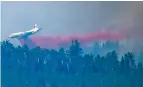  ?? DARRYL DYCK/CANADIAN PRESS VIA AP ?? A tanker drops retardant last week while battling the Shovel Lake Fire near Fraser Lake, British Columbia. There is a shortage of such planes.