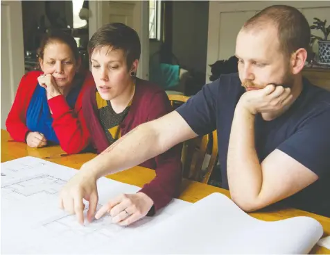  ?? GERRY KAHRMANN / PNG ?? Janet Féirín, left, looks over plans for an infill house on her East Vancouver property with son Kristoffer Knutson and his wife, Mandy Knutson. “I can see the kids taking over the (main) house eventually,” Féirín says.