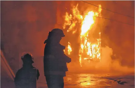  ?? ADAM MACINNIS/THE NEWS ?? Firefighte­rs battle the March 19 blaze in Pictou that burned a laundromat and bottle exchange depot.