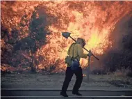  ?? PAUL BUCK/EPA-EFE ?? A firefighte­r heads to battle flames alongside the 210 freeway in Sunland, Calif. Los Angeles Mayor Eric Garcetti has called the wildfire the largest in the city’s history.