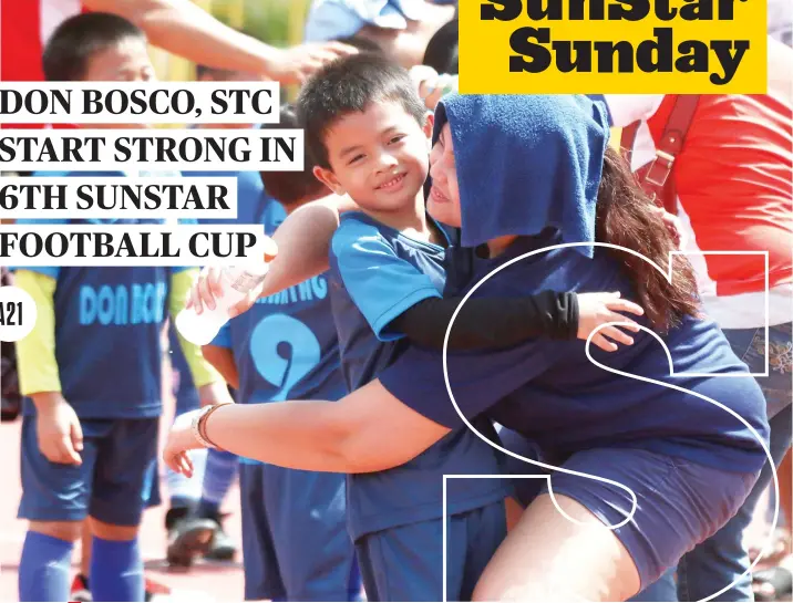  ?? SUNSTAR FOTO / ALEX BADAYOS ?? ONE OF 3 TITLES FOR DON BOSCO SO FAR. Players in the Don Bosco Technology Center’s under-7 squad celebrate their win on the first day of the 6th SunStar Football Cup, which will continue today in the Cebu City Sports Center.