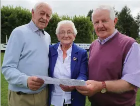  ??  ?? Donal Duane, Tess Buckley and Tom Joe Duane who’s fathers were members of the 1918 Meelin Team checking out the historic team photograph from 100 years ago.