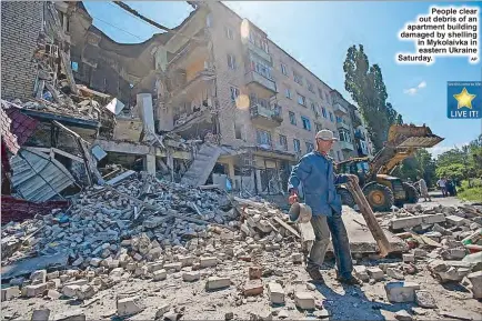  ?? AP ?? People clear out debris of an apartment building damaged by shelling in Mykolaivka in eastern Ukraine Saturday.