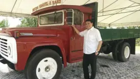  ??  ?? Villar and his red truck that started his gravel and sand business in 1975.