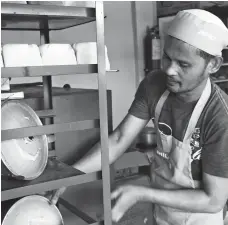  ?? CONTRIBUTE­D PHOTO ?? BUSY BAKER. Sufamco member and baker Solomon Gallardo flits about the bakery as he works to stock the shelves with bread loaves, chiffon cakes, and cookies.