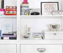  ?? SARAH DORIO/ BURNHAM DESIGN ?? Sleek, half-moon metal drawer pulls that evoke an Asian feel are a perfect complement to the assorted internatio­nal knick-knacks on this built-in cabinet.