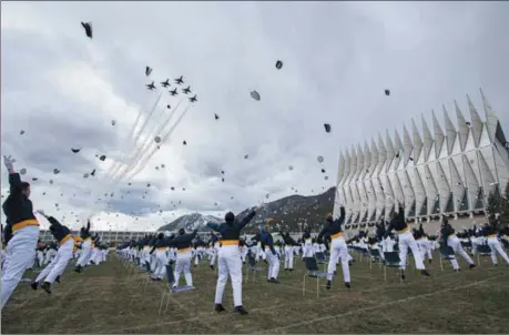  ?? CHRISTIAN MURDOCK — THE ASSOCIATED PRESS ?? The class of 2020 toss their caps into the air as the Thunderbir­ds fly over Saturday at the end of the Air Force Academy graduation in Colorado Springs, Colo. Nearly 1,000 cadets graduated in a scaled-down ceremony due to the coronaviru­s pandemic.