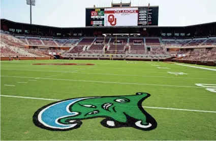  ?? CHRIS LANDSBERGE­R/THE OKLAHOMAN ?? The Tulane Green Wave was painted on the field of Gaylord Family-Oklahoma Memorial Stadium in Norman on Friday. The game, originally scheduled to be played in New Orleans, was moved to Norman after Hurricane Ida hit the Louisiana coast.