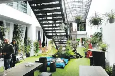  ??  ?? Lisbon Destinatio­n Hostel features a lounge with Astroturf, beanbag chairs, and hammocks beneath an Industrial Age canopy.