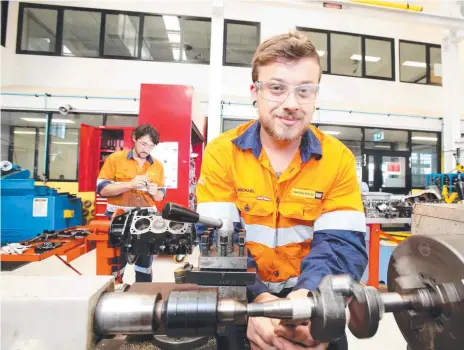  ?? Picture: AAP/Steve Pohlner ?? MAKING MOVES: Apprentice engine reconditio­ners Michael Cawthra, front, and Mick Smith say they would consider relocating for work.