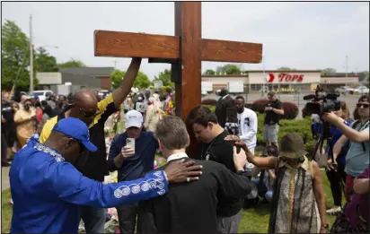  ?? JOSHUA BESSEX — ASSOCIATED PRESS FILE ?? A group prays at the site of a memorial for the victims of the shooting outside the Tops Friendly Market on May 21 in Buffalo, N.Y.