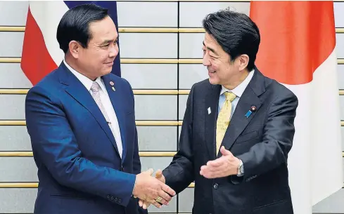  ?? REUTERS ?? Prime Minister Prayut Chan-o-cha, left, and his Japanese counterpar­t Shinzo Abe shake hands before holding talks at Mr Abe’s official residence in Tokyo yesterday. Gen Prayut is in Japan on a three-day visit.