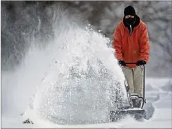  ?? CHARLIE RIEDEL — THE ASSOCIATED PRESS ?? John Tapko clears snow at his house Wednesday in Overland Park, Kan.