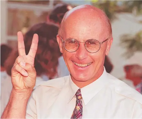  ??  ?? Liberal McPherson MP John Bradford gives a victory sign in 1996; (below) Gold Coast mayoral candidates Bradford and Tom Tate in 2008 and the Bulletin’s front page coverage of Peter Costello’s Federal Budget in 1998.