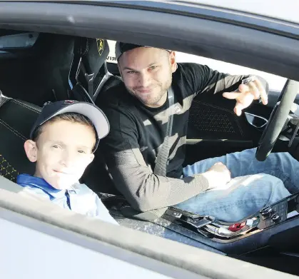  ?? ANDREW McCREDIE ?? He’s definitely one of the good guys. Kevin Gordon is shown at the wheel of his Lamborghin­i Huracan about to take a young man for a thrill ride at the Aidan’s Cup, a Children’s Wish Foundation of Canada fundraiser.