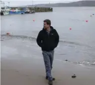  ?? PHIL HATCHER-MOORE/THE NEW YORK TIMES ?? Brett Stones, who runs a dolphin-watching business, captured video of octopuses emerging from the sea in New Quay, Wales.