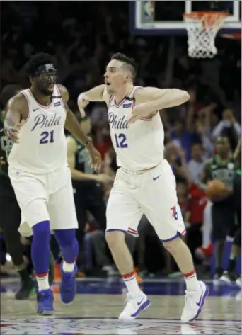  ?? MATT SLOCUM — THE ASSOCIATED PRESS ?? Sixers guard T.J. McConnell, right, had plenty to celebrate Monday night, tallying a careerhigh 19 points in 39 minutes in his first postseason start to spark a 103-92 win over Boston in Game 4.