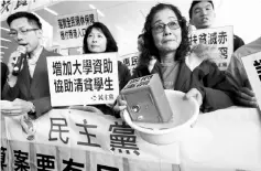  ??  ?? A protester carries a safe in water to mock the government’s fiscal policy before the release of the annual budget report in Hong Kong. Hong Kong handed out billions in tax cuts and poverty relief yesterday, to stimulate its economy that is expected to...