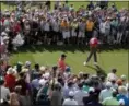  ?? CHARLIE RIEDEL — THE ASSOCIATED PRESS ?? Tiger Woods hits his tee shot on the eighth hole during practice for the Masters at Augusta National Golf Club, Monday in Augusta, Ga.